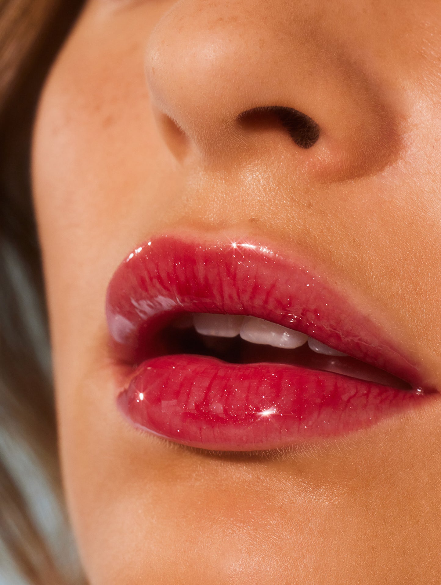 Close up image of a model lips wearing lanolips glossy balms berry lip balm.