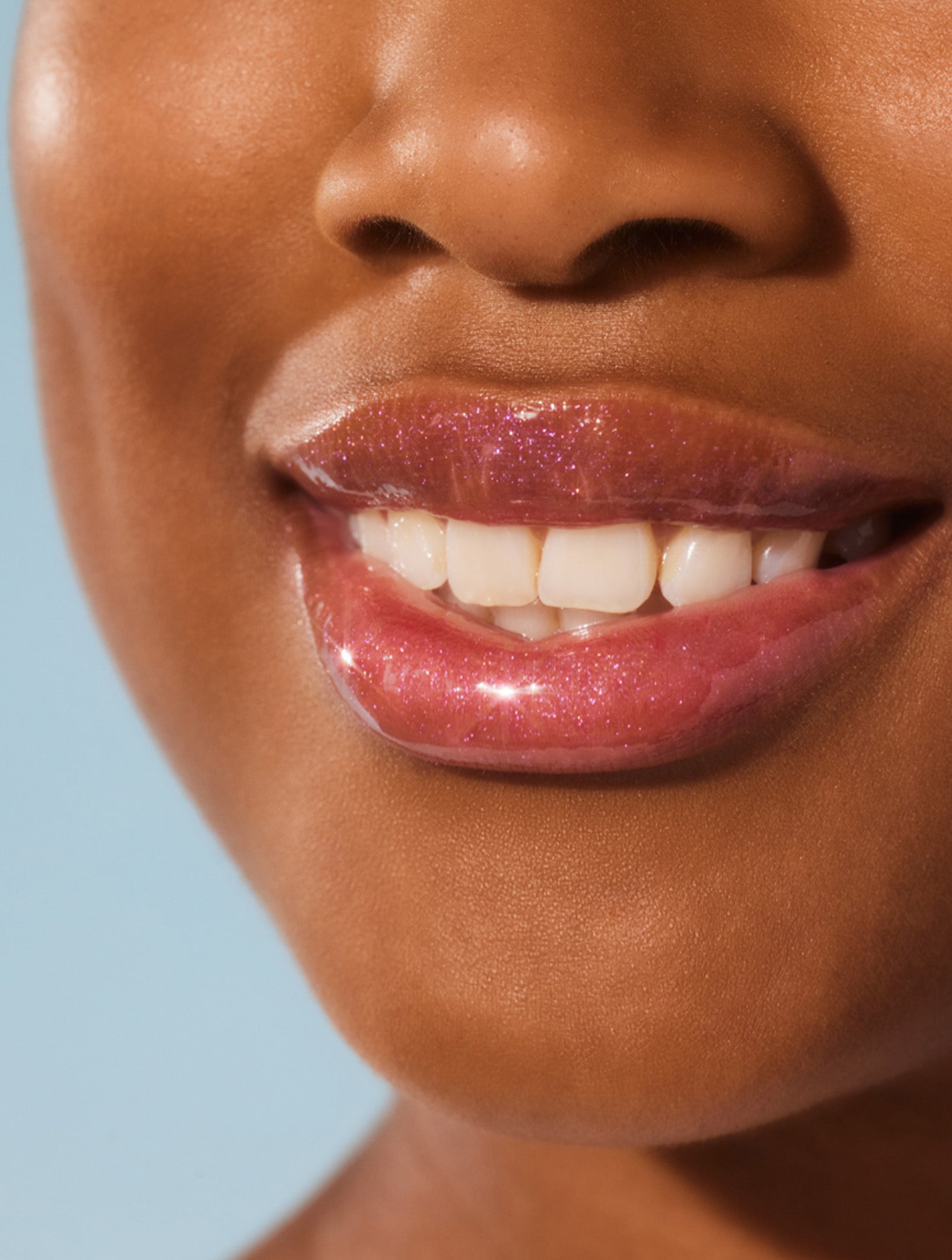 Model wearing Lanolips Liquid Lip Water, hydrate your deeper layers, leaving your lips glistening and soft.