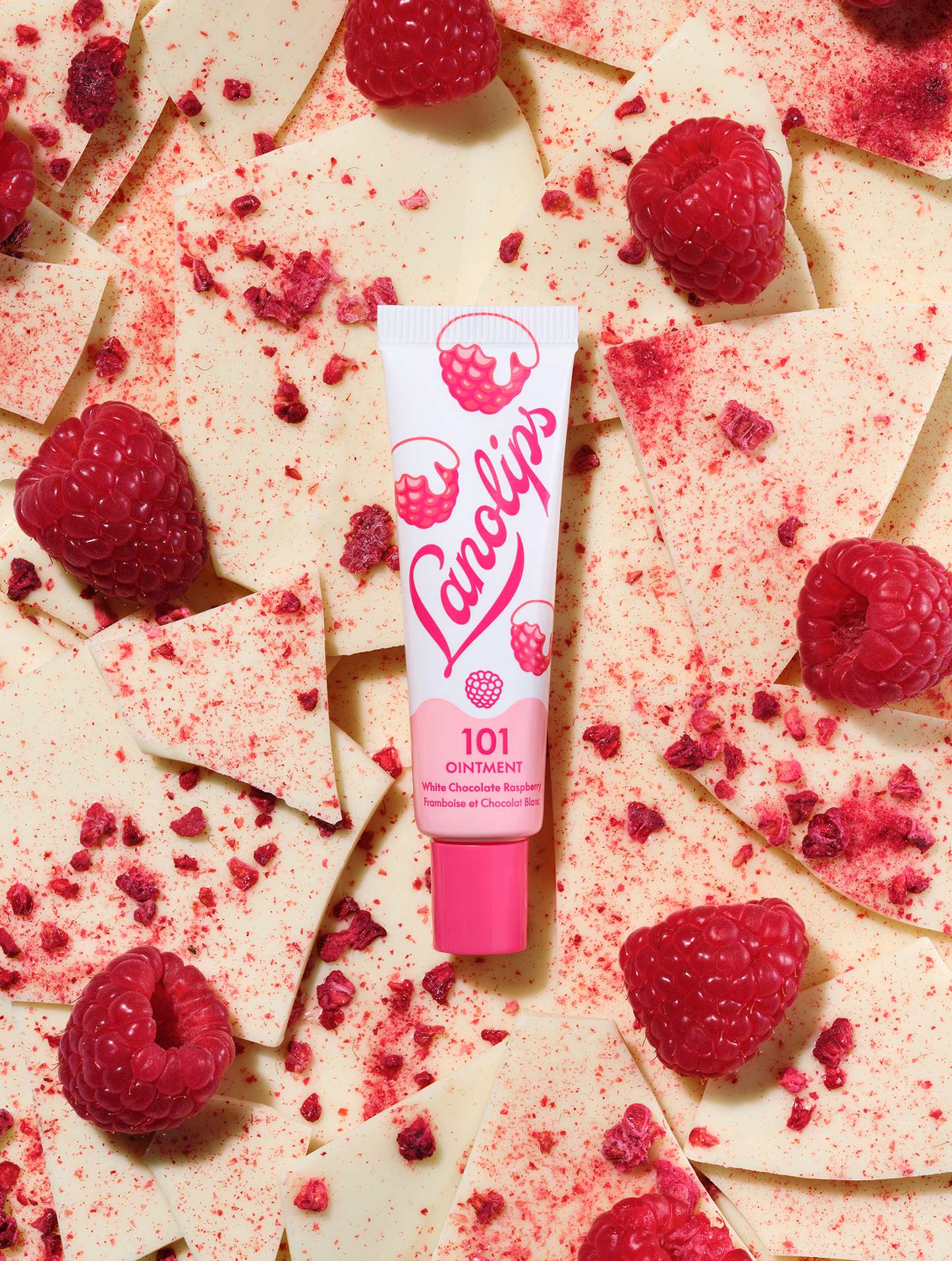 Lanolips 101 Delicious collection: 101 Ointment Multi-Balm White Chocolate Raspberry. A tube of lips-loving hydration set against creamy white chocolate and a fresh burst of raspberries. This 100% natural lanolin balm turns a classic flavour combo into a sweet, hydrating treat.